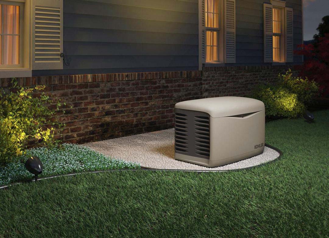 a residential kohler generator installed outside of a house