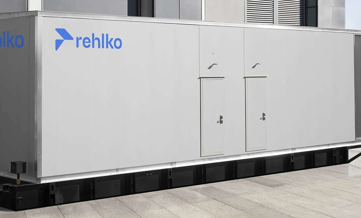 Large gray outdoor energy-system enclosure labeled “rehlko,”
